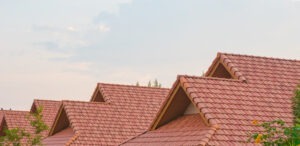 view of peaks of tile roofline in a neighborhood