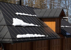 overhead view of metal roof of house with snow